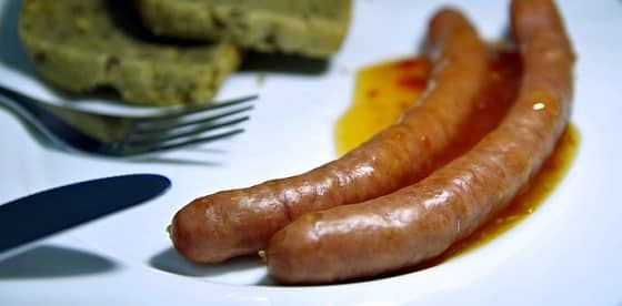 Andouille a la Jeannine. Sausage simmered in white wine, creole mustard and honey.